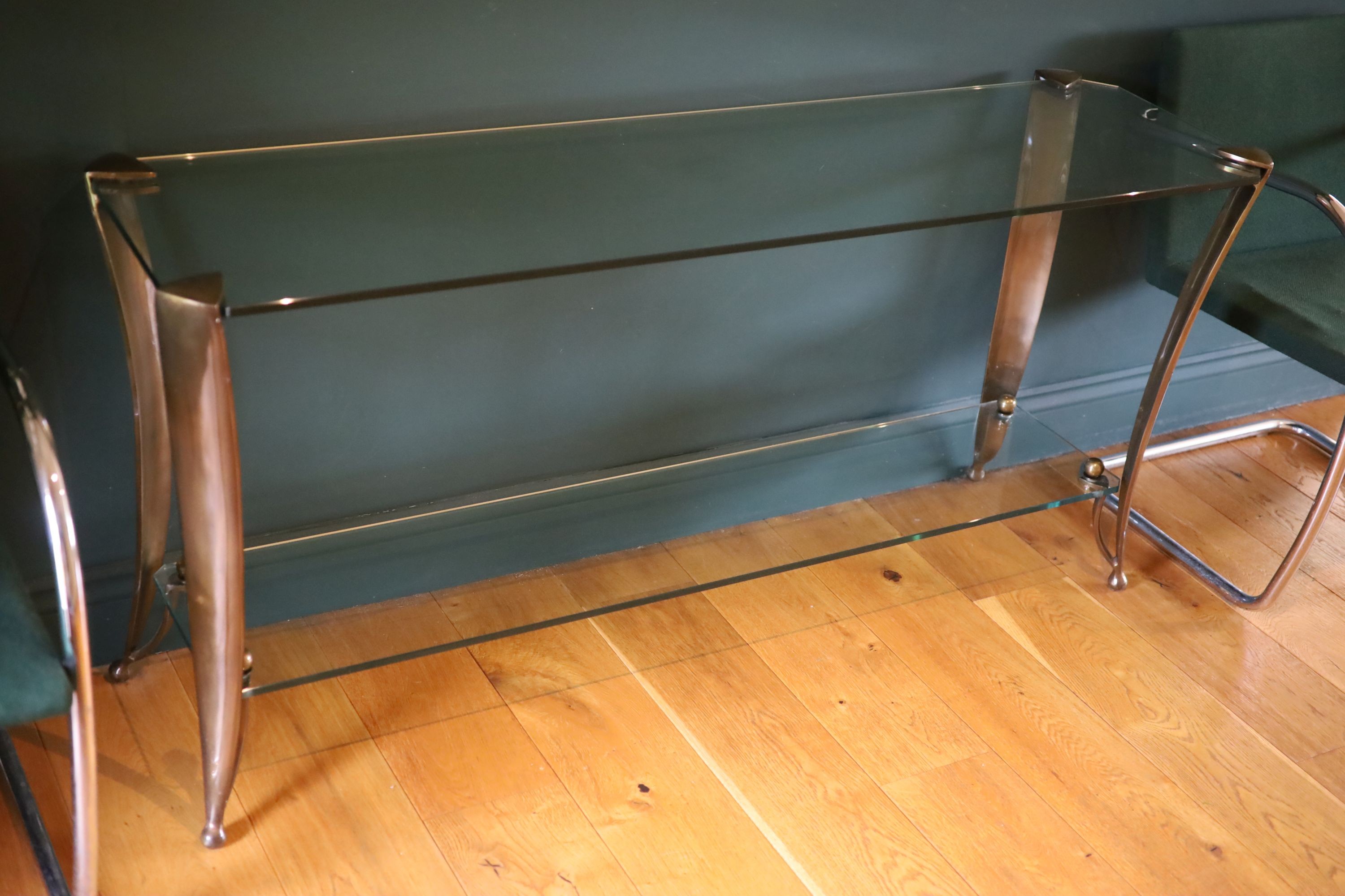 An Art Deco style bronze and glass two tier console table, width 153cm depth 44cm height 73cm
